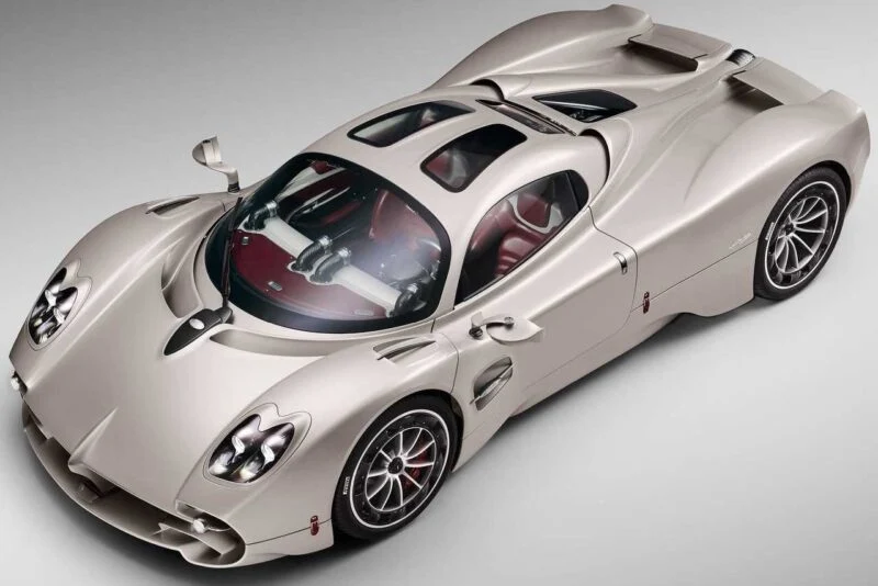 Overhead view of a silver sports car with a sleek aerodynamic design, red and black interior, and distinctive curves—reminiscent of the Pagani models set to showcase four hypercar icons at the upcoming 9th Historic Minardi Day in Imola.