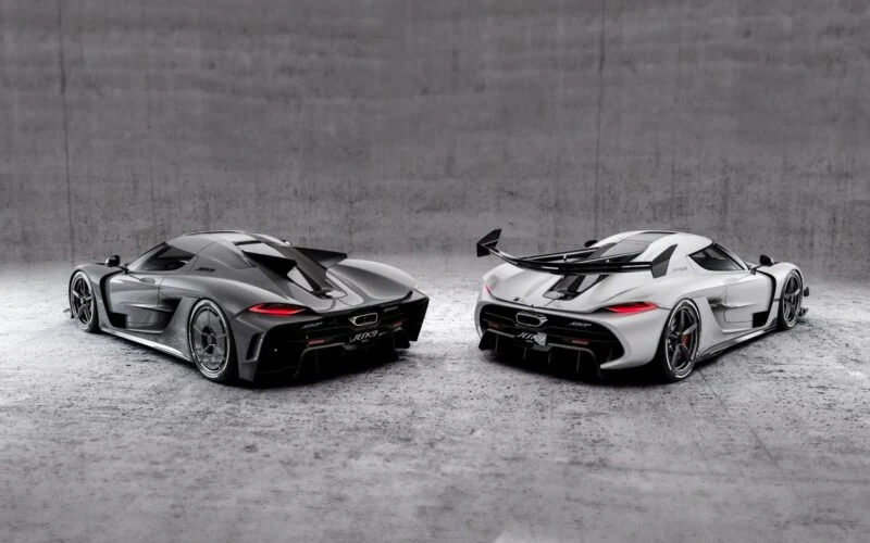 Two high-performance sports cars, including a Koenigsegg track-focused hypercar, are parked side by side in a minimalist, concrete indoor setting, awaiting their June 25 reveal.