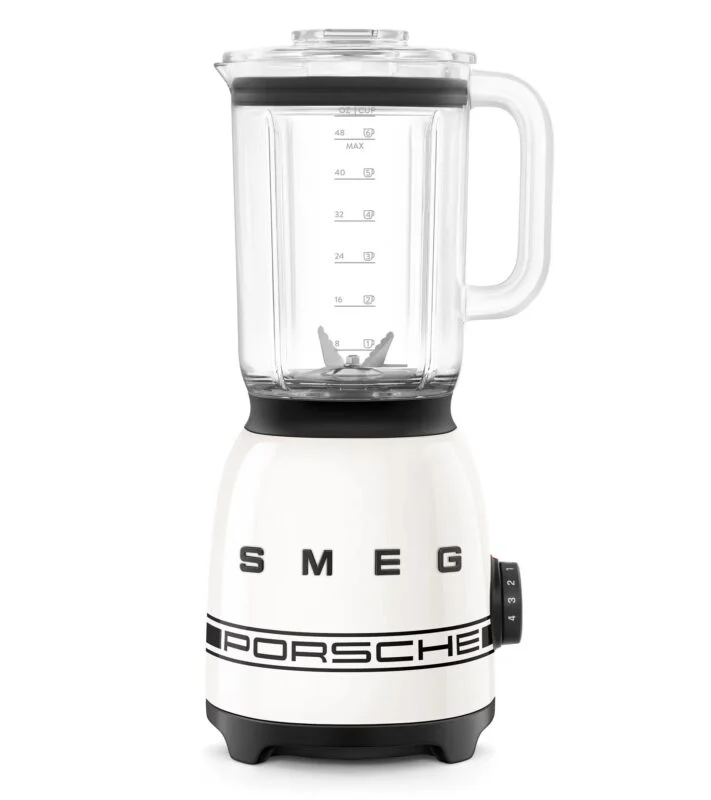 A white SMEG blender featuring a clear glass pitcher, black detailing, and a