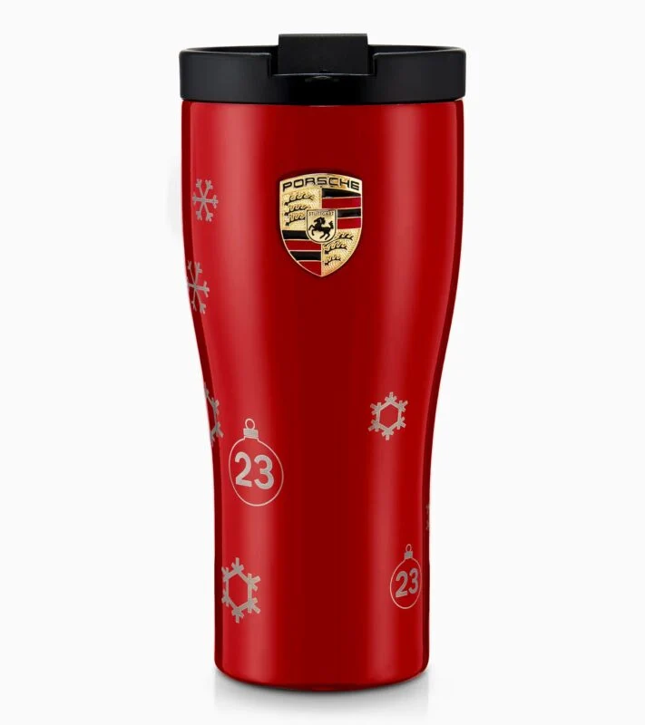 Red travel mug with the Porsche logo, black lid, and white snowflake and ornament designs featuring the number 23—an ideal pick from the Holiday Gift Guide by Porsche Design.
