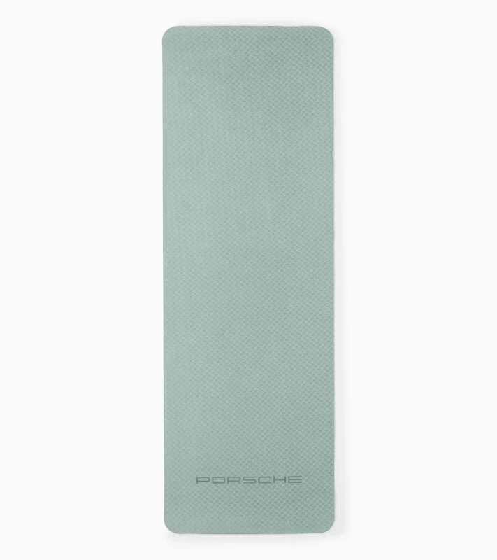 A light grey rectangular exercise mat with a subtle textured surface and the word