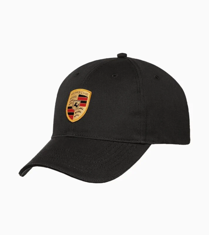 Black baseball cap featuring a gold Porsche crest logo on the front, showcased against a plain white background. A stylish pick from the 2025 Porsche Design collection and a standout in any Holiday Gift Guide.