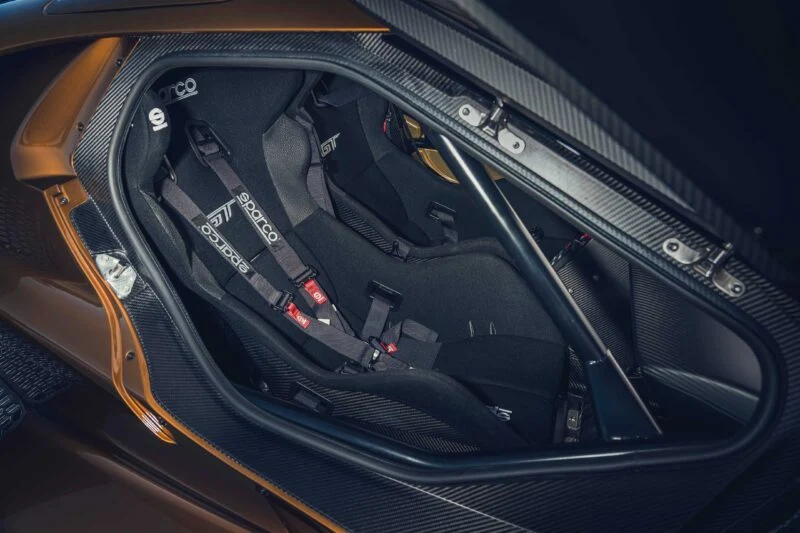 Close-up view of a racing car cockpit featuring two bucket seats with Sparco harnesses and visible carbon fiber interior panels, inspired by the Ford Performance Launches Final Production Run of Legendary Ford GT Mk IV.